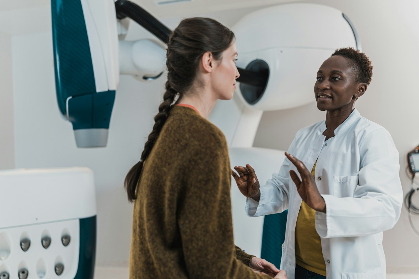 Woman speaking with a clinician in a medical room